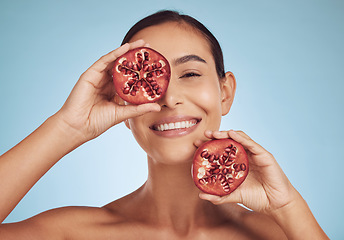 Image showing Woman, skincare portrait and pomegranate for eye beauty, natural cosmetics and facial product or vitamin c benefits. Face of person, red fruits and dermatology or skin care on studio, blue background