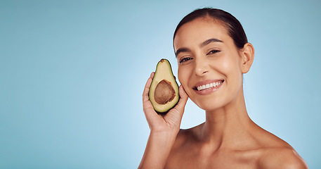 Image showing Woman, avocado and portrait, natural beauty and skincare with eco friendly product isolated on blue background. Mockup space, happy female model and banner, fruit and sustainability in dermatology