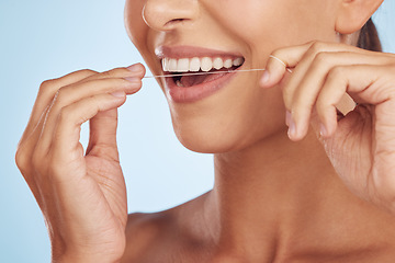 Image showing Teeth, flossing and woman with dental and hands, hygiene and grooming with oral care isolated on blue background. Closeup of female model cleaning mouth, health and morning routine and prevent cavity