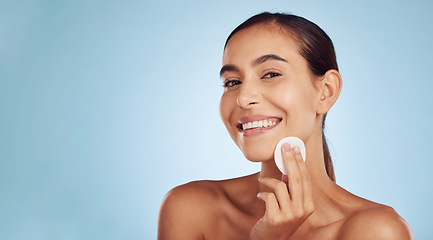 Image showing Happy woman, portrait and cotton pad for skincare or makeup removal against a blue studio background. Female person or model smile with swab for cosmetics, foundation or facial treatment on mockup