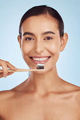 Image showing Brushing teeth, portrait and woman with dental, hygiene and grooming with oral care isolated on blue background. Female model cleaning mouth, health and morning routine and toothbrush with toothpaste