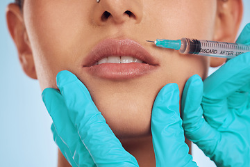 Image showing Closeup, woman and plastic surgery with a needle, lip filler and cosmetics against a blue studio background. Zoom, female person or model with injection, dermatology and beauty with medical procedure