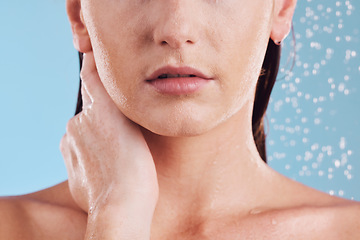 Image showing Woman, hands and shower in water for hygiene, cleaning or self love and body care against a blue studio background. Closeup of female person in skincare, rain or wash for cleanliness or grooming