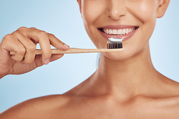 Image showing Brushing teeth, toothbrush and woman with dental, hygiene and grooming with oral care isolated on blue background. Female model cleaning mouth, health and morning routine and toothpaste with smile