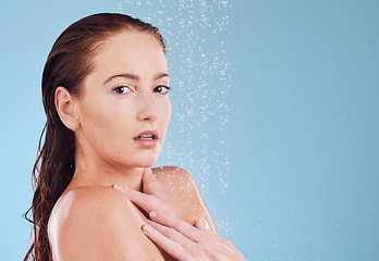Image showing Shower, portrait and skincare with cleaning and woman in studio or blue background for wellness. Girl, cosmetics and water with beauty routine for hygiene or self love with dermatology in bathroom