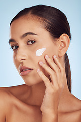 Image showing Cream on face, beauty and woman with skincare, cosmetic product isolated on blue background. Portrait, moisturizer and lotion for skin, sunscreen and dermatology, female person and anti aging facial