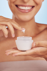 Image showing Cream in container, beauty and woman hands with skincare, cosmetic product on blue background. Closeup, moisturizer and lotion for skin, sunscreen and dermatology, female person and anti aging