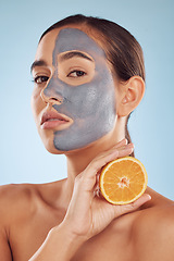 Image showing Portrait, face mask and orange with beauty and skincare, eco friendly product and cosmetic on blue background. Charcoal facial, citrus fruit and vitamin c, female model has skin detox and dermatology