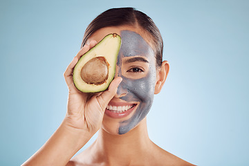 Image showing Avocado, face mask and woman in portrait for natural skincare, beauty and spa on studio blue background. Happy person or model with charcoal facial, green fruits and vitamin d benefits in dermatology