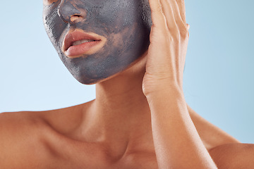Image showing Face mask, charcoal and beauty of woman with cosmetic facial treatment isolated in a blue studio background. Skin, skincare and young female person with clean, hydration and dermatology cream
