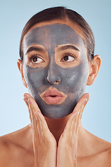 Image showing Face mask, skincare and beauty of woman with cosmetic facial treatment isolated in a blue studio background. Skin, charcoal and young female person with clean, hydration and dermatology cream