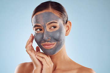 Image showing Clay face mask, skincare and woman with beauty in studio isolated on blue background. Cosmetics, model and natural facial treatment for peeling to exfoliate skin, dermatology or cleaning for wellness