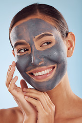 Image showing Woman thinking, face mask and charcoal for skincare, natural beauty and cosmetics benefits on studio, blue background. Ideas of happy person or model with facial collagen, skin care and dermatology