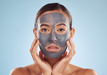 Image showing Face mask, skincare and woman with beauty, dermatology and girl on a blue studio background. Portrait, female person and model with cosmetics, glow and aesthetic with hygiene, hydration and charcoal