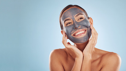 Image showing Woman, face mask and thinking of charcoal skincare, natural beauty and cosmetics benefits on studio, blue background. Ideas of person or model for facial collagen, skin care and dermatology on banner