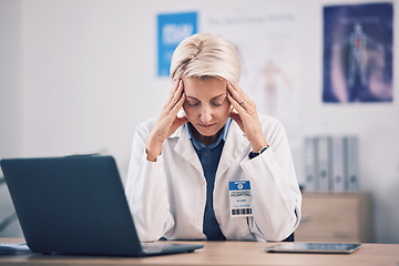 Image showing Headache, doctor and pain of woman at laptop in medical office in burnout, mental health problem and stress. Frustrated, tired and mature healthcare worker in fatigue, migraine and anxiety of mistake