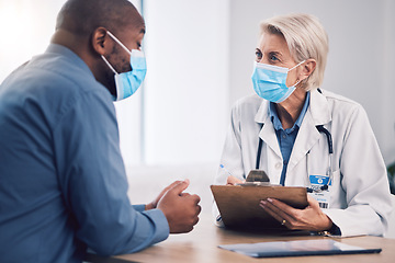 Image showing Woman, doctor and clipboard for consultation with patient, checkup or life insurance on desk at hospital. Female person, medical or healthcare expert with face mask consulting customer at the clinic