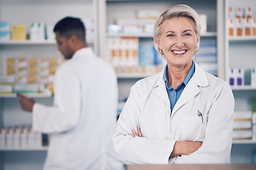 Image showing Woman, portrait and pharmacist smile with arms crossed for medical services, medicine advice and healthcare support. Mature female manager working with pride in retail drugstore, pharmacy and shop