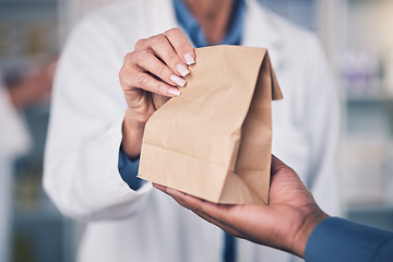 Image showing Woman, pharmacist and hands with paper bag for patient, healthcare or medication at the pharmacy. Closeup of female person or medical professional giving pills, drugs or pharmaceuticals to customer