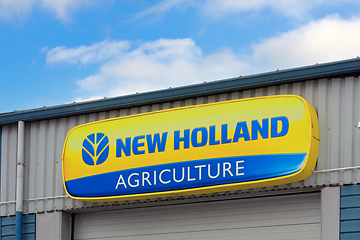 Image showing New Holland Agriculture Logo at Dealership with Beautiful Sky