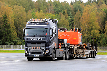 Image showing Black Volvo FH16 Truck Hauls Excavator