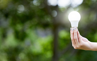 Image showing Nature, hand and lightbulb for knowledge, energy or sustainability with solar power. Creative, innovation and person with bulb for eco friendly electricity, green solution or inspiration with mockup