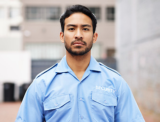 Image showing Portrait, man and serious security guard for police service, crime protection and safety in city street. Law enforcement, professional bodyguard and asian male officer in blue shirt outdoor on patrol