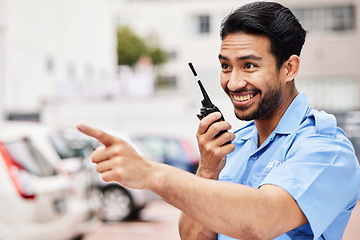 Image showing Happy, pointing and security with a walkie talkie in the city for communication on parking lot safety. Smile, thinking and an Asian worker with gear for talking and a warning in town for work