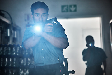 Image showing Flashlight, police and man with gun for investigation, inspection and property search at night. Surveillance team, law and security male person in dark room for safety, crime and protection service