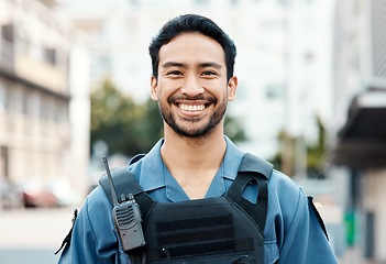 Image showing Portrait, happy or policeman in city for law enforcement, community protection or street safety. Face of cop, supervisor or proud Asian security guard on patrol in urban town for crime or justice