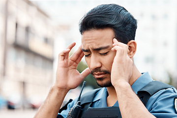 Image showing Stress, danger or policeman in city with headache, anxiety or burnout working for justice or law enforcement. Tired cop, legal or security guard with head pain, emergency crisis or migraine on street