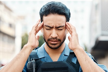 Image showing Stress, crisis or policeman in city with headache, anxiety or burnout working for justice or law enforcement. Tired cop, sheriff or security guard with head pain, emergency or migraine on street road