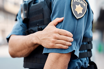 Image showing Man, police and arm injury in city from accident, gun shot or pain in discomfort outdoors. Closeup of male person, officer or security guard with painful joint, inflammation or wound in an urban town