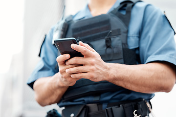 Image showing Man, police and hands with phone for networking, communication or social media in the city. Closeup of male person or officer typing, texting or chatting on mobile smartphone app in an urban town