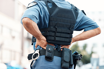 Image showing Back pain, man or police officer with injury in city from accident crime, crisis danger or gunshot emergency. Law closeup, injured or security guard with painful joint, inflammation or wound in town