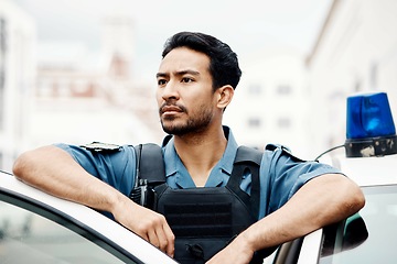 Image showing Police, thinking and man officer by a car for an investigation or patrol for law protection in city or urban town. Criminal, safety and legal service guard or security on duty for justice enforcement