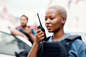 Image showing Black woman, police and walkie talkie for radio in city communication, reinforcement or emergency. African female person, security guard or cop calling backup for crime on patrol in urban town street