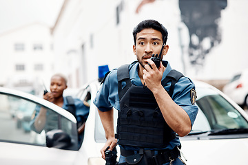 Image showing Asian man, police and walkie talkie for suspect in city communication, reinforcement or emergency. Serious male person, security guard or cop radio calling backup for crime in street of an urban town
