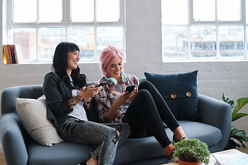 Image showing Phone, education and students with women friends sitting on a sofa in the campus breakroom at college. Social media, university and young female pupils reading a text message while on break to relax