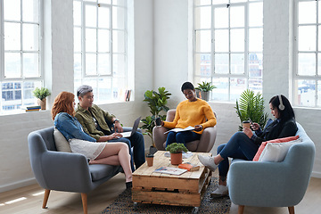 Image showing Creative, discussion and business people in the office lounge or coworking space planning project in collaboration. Teamwork, diversity and team working together with technology on sofa in workplace.