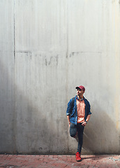 Image showing Young man, student and relax against wall, headphones and music on university campus with future and mindset. Gen z, scholarship and male person at college, mockup space with studying and thinking