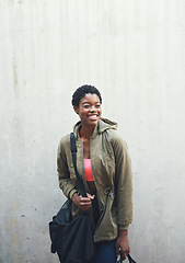 Image showing Education, thinking and smile with a woman student leaning against a gray wall on the campus of her university. Scholarship, idea and future with a happy young female pupil learning at college