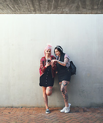 Image showing Friends, smartphone and students, women against wall background with social media and check chat online. Young female people on college campus, using phone and app, punk fashion and communication