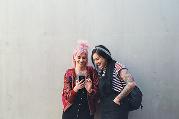 Image showing Friends, cellphone and students, women and wall background with social media and check chat online. Female people on college campus, using phone and mobile app with punk fashion and communication