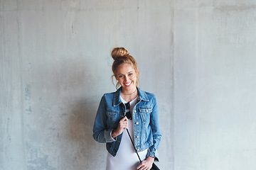 Image showing Portrait, education and happy with a woman student leaning against a gray wall on the campus of her university. Smile, study and scholarship with a young female pupil standing at college for learning