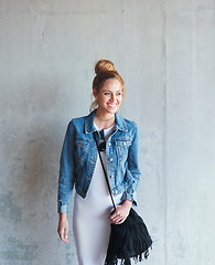 Image showing Education, thinking and happy with a woman student leaning against a gray wall on the campus of her university. Scholarship, happy and idea with a young female pupil standing at college for learning