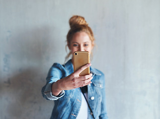 Image showing Selfie, influencer and woman on social media with phone in hand, smile and wall background. Happy face of young content creator, digital photography and girl streaming video with online mobile app.