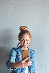 Image showing Selfie, mockup and happy woman on social media with phone in hand, smile and wall background. Face of young content creator, digital photography and girl streaming video space with online mobile app.