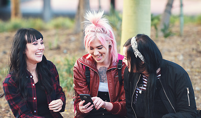 Image showing Friends, smartphone and students, women outdoor in college park with social media and laughing at meme online. Young female people at campus, using phone and mobile app, funny text and communication
