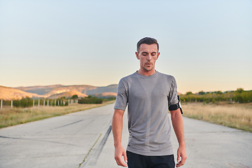 Image showing A young handsome man running in the early morning hours, driven by his commitment to health and fitness